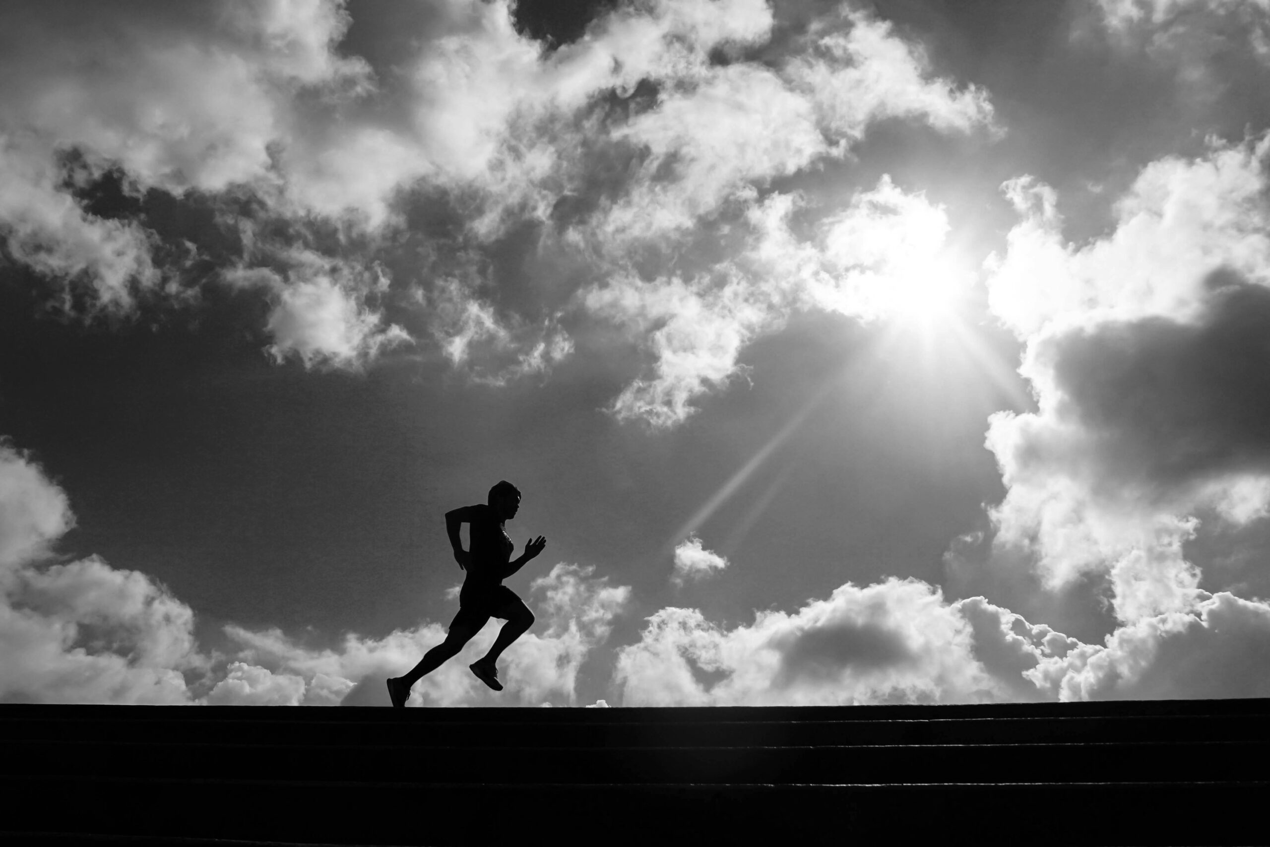 Runner beneath dramatic clouds